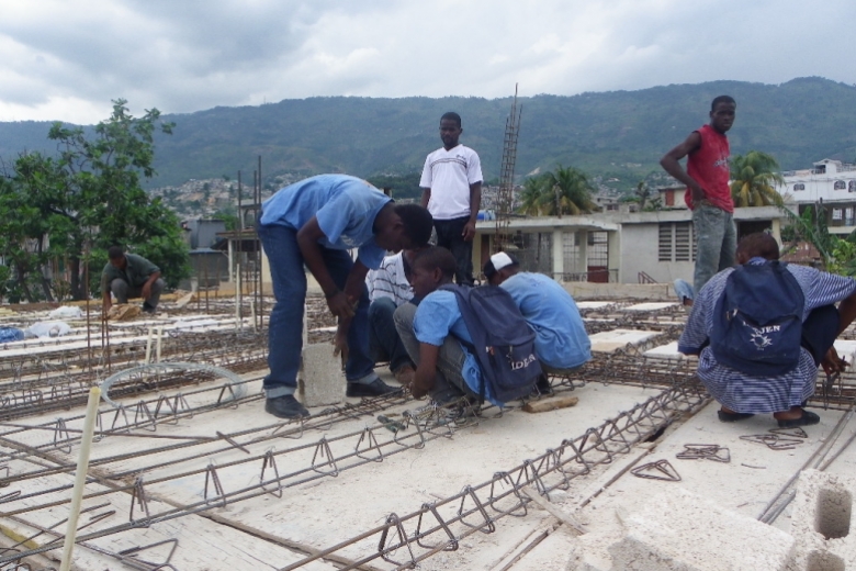 Young adults work on a construction project with rebar.
