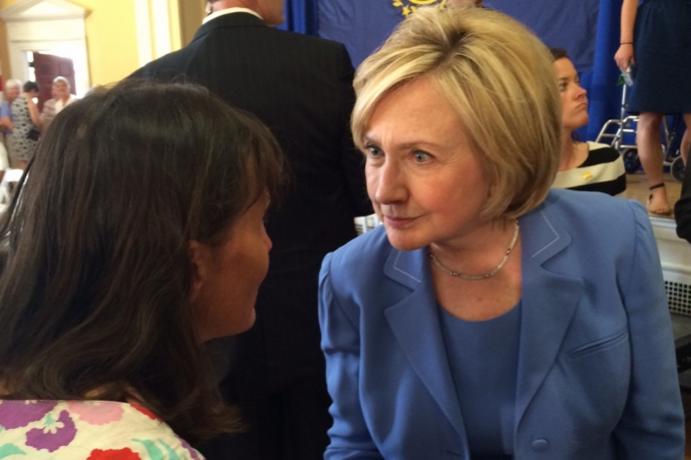 Young woman talking with Hillary Clinton.